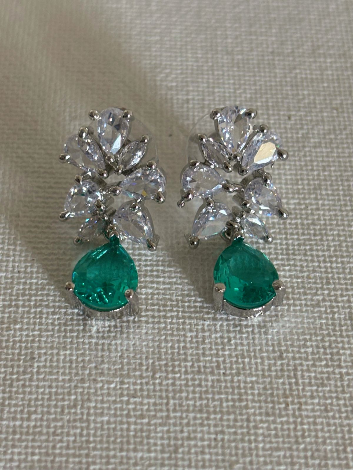 Shop Subtle Glow Green Stone Drop AD Earrings online in India. Shop from an exclusive range of zircon jewellery, bridal wedding jewelry, silver plated earrings, rhodium plated jewellery, AD earrings, AD necklace sets for Lehengas, suits, sarees and gowns. -front