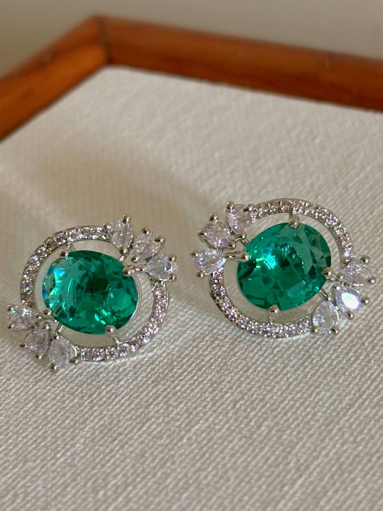 Shop Celebrity Studs In AD & Green stone online. Shop from an exclusive range of zircon earrings, bridal AD jewelry, silver plated earrings, rhodium plated jewellery, AD earrings, AD necklace sets for weddings, engagements and parties. -Front