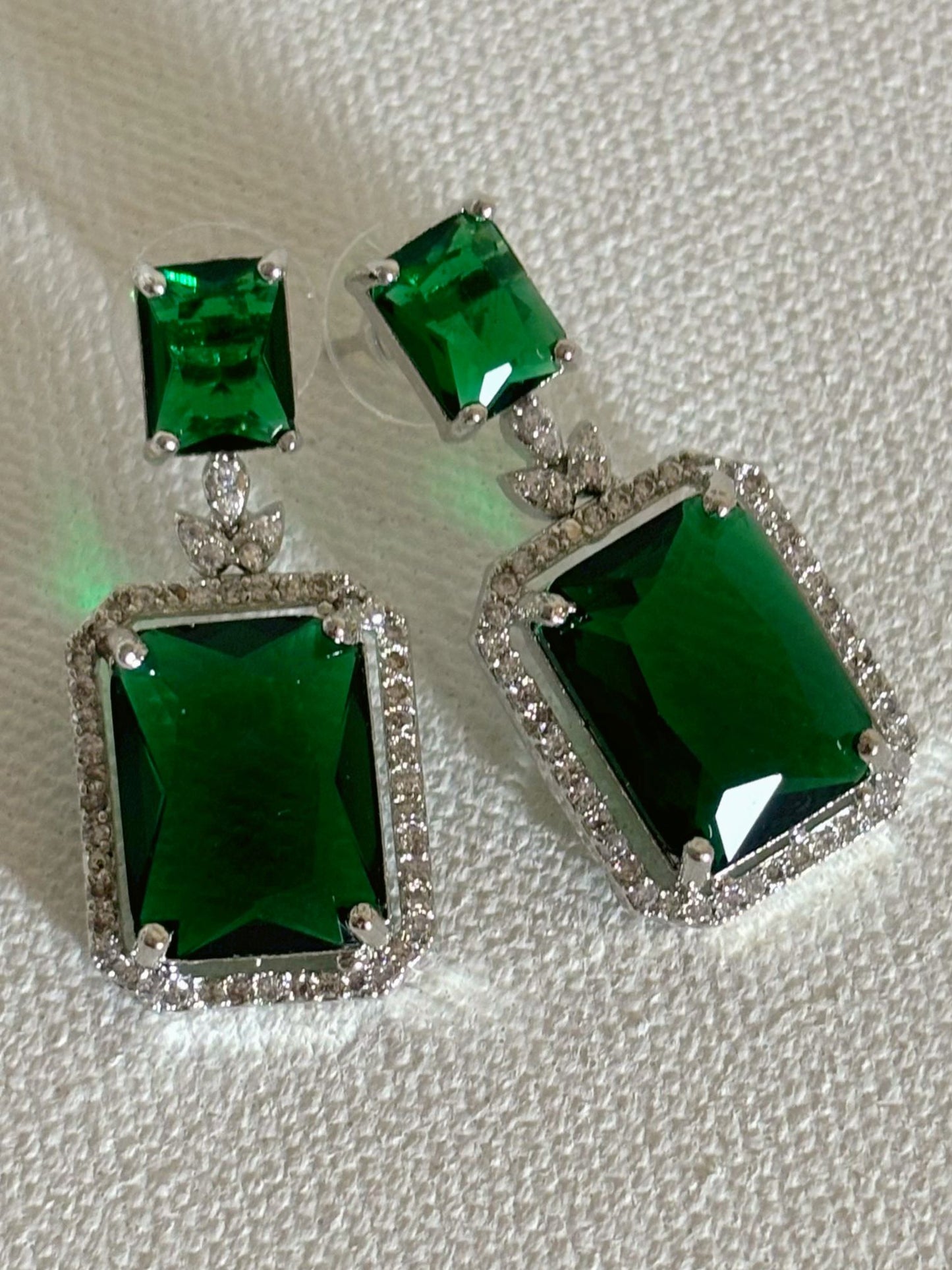 Shop women's luxury white doublet stone AD earrings online in India. Shop from an exclusive range of zircon jewellery, Indian wedding jewelry, AD earrings with saree, rhodium plated jewellery, AD necklace sets for weddings and engagement. AD jewellery in green stone. -Front
