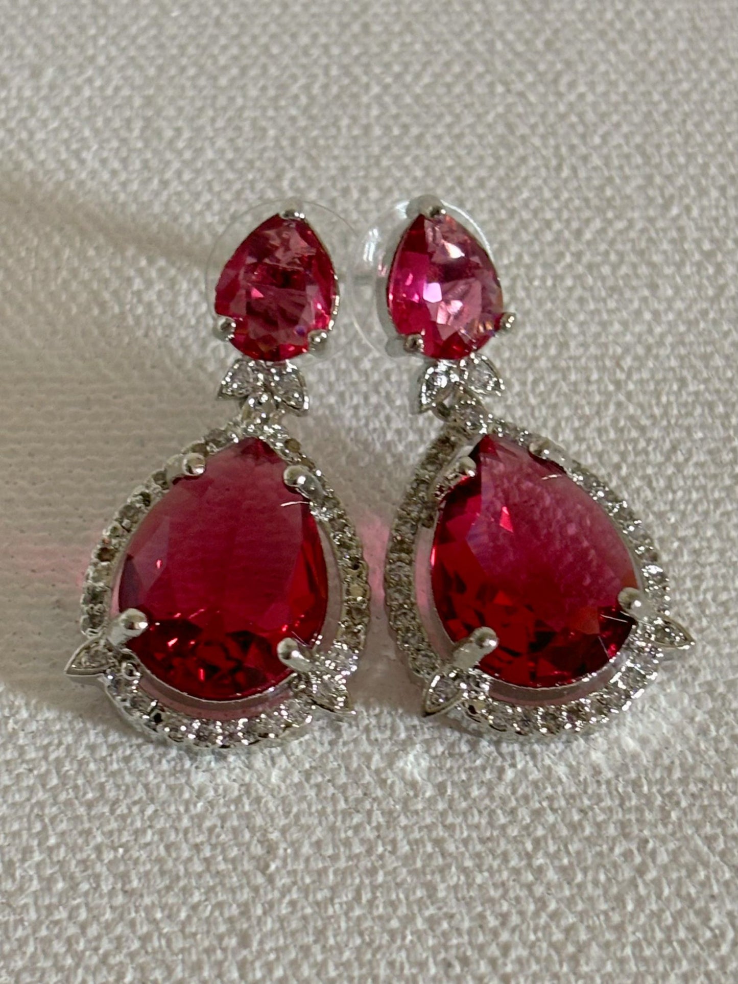 Shop Celebrity Look Double Drop Red Stone AD Earrings online. Shop from an exclusive range of zircon earrings, bridal AD jewelry, silver plated earrings, rhodium plated jewellery, AD earrings, AD necklace sets for coats, gowns and lehengas. -front