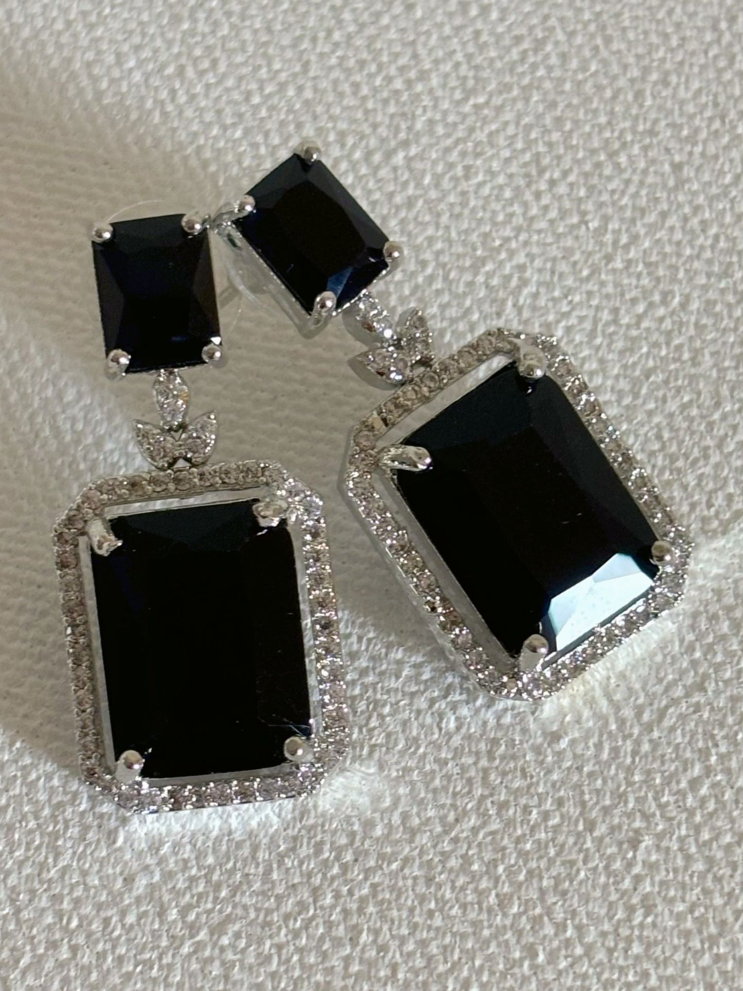 Shop women's luxury white doublet stone AD earrings online in India. Shop from an exclusive range of zircon jewellery, Indian wedding jewelry, AD earrings with saree, rhodium plated jewellery, AD necklace sets for weddings and engagement. AD jewellery in black stone. -front