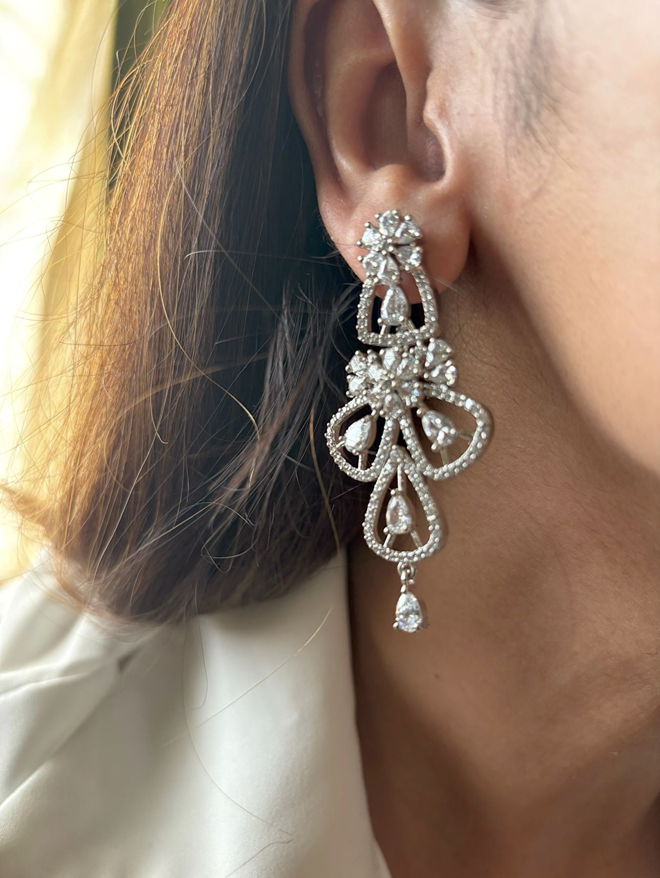 Shop women's Flower Shaped Long AD Earrings In White online in India. Shop from an exclusive range of zircon jewellery, Indian wedding jewelry, gold plated earrings, rhodium plated jewellery, AD earrings, AD necklace sets for weddings, engagements and parties. -front
