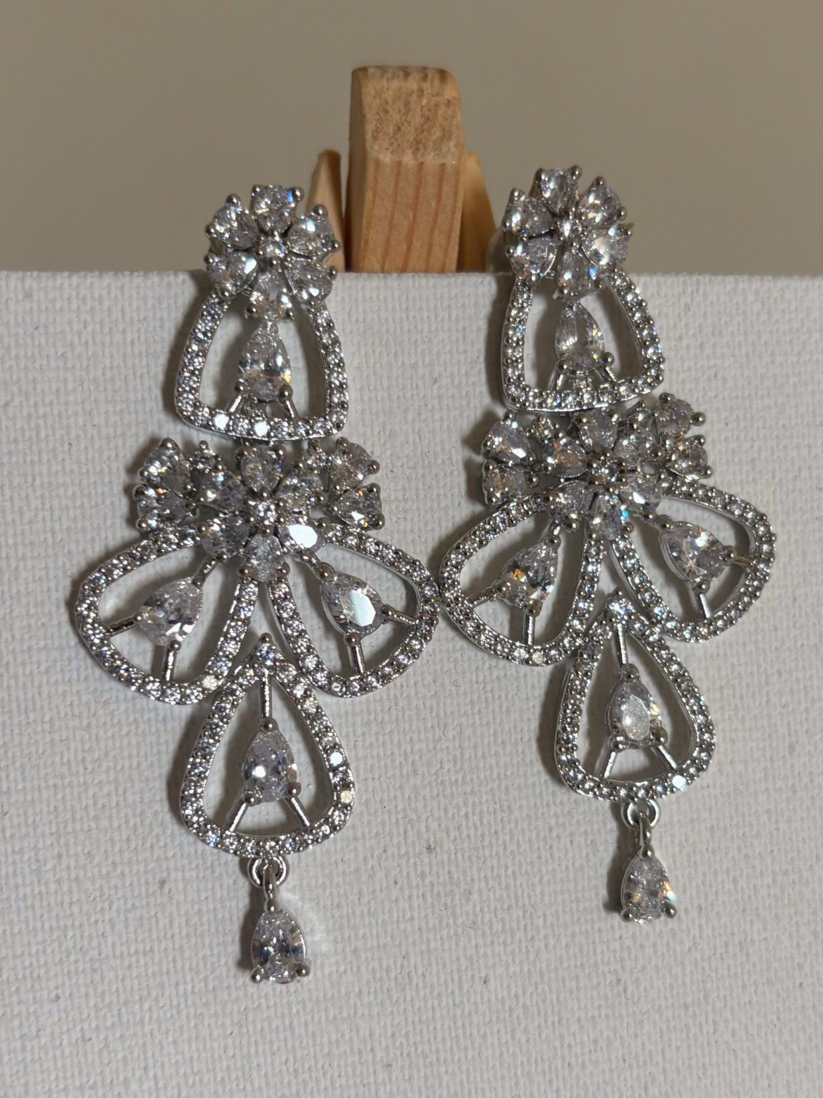Shop women's Flower Shaped Long AD Earrings In White  online in India. Shop from an exclusive range of zircon jewellery, Indian wedding jewelry, gold plated earrings, rhodium plated jewellery, AD earrings, AD necklace sets for weddings, engagements and parties.  -first