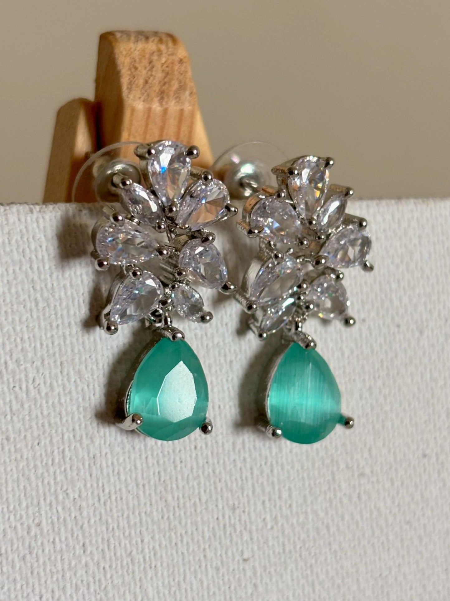 Shop Subtle Glow Mint Green Stone Drop AD Earrings online in India. Shop from an exclusive range of zircon jewellery, bridal wedding jewelry, silver plated earrings, rhodium plated jewellery, AD earrings, AD necklace sets for Lehengas, suits, sarees and gowns. -front