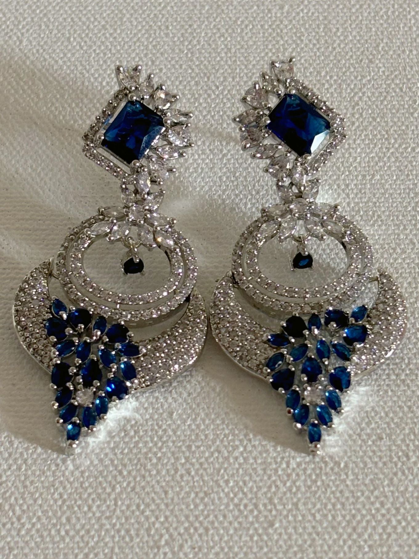 Shop women's Designer AD Earrings With Blue Stone online in India. Shop from an exclusive range of zircon jewellery, bridal wedding jewelry, silver plated earrings, rhodium plated jewellery, AD earrings, AD necklace sets for Lehengas, suits, sarees and gowns. -front