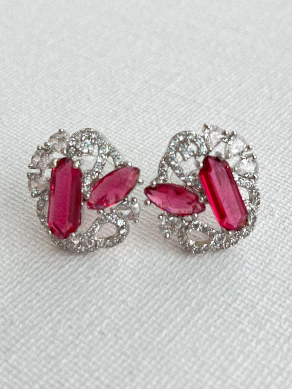 Shop Gauri Red Stud Earrings In AD online in India. Shop AD earrings, bridal AD jewelry, AD necklace sets for weddings, engagements and parties.