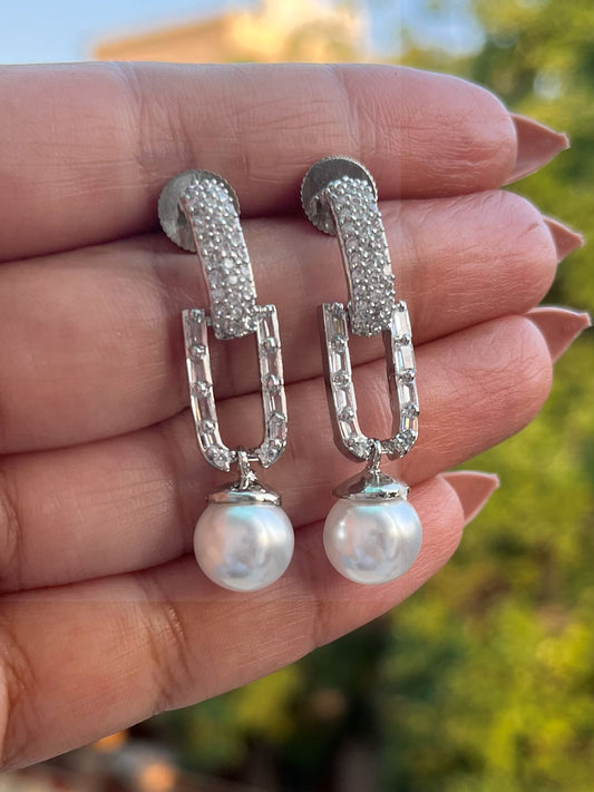 Shop Elegant Pearl Drop Long AD Earrings In Gold Polish online in India. Shop from an exclusive range of zircon jewellery, Indian wedding jewelry, gold plated earrings, rhodium plated jewellery, AD earrings, AD necklace sets for weddings, engagements and parties.  -front