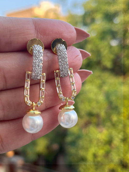 Shop Elegant Pearl Drop Long AD Earrings In Gold Polish online in India. Shop from an exclusive range of zircon jewellery, Indian wedding jewelry, gold plated earrings, rhodium plated jewellery, AD earrings, AD necklace sets for weddings, engagements and parties. -front