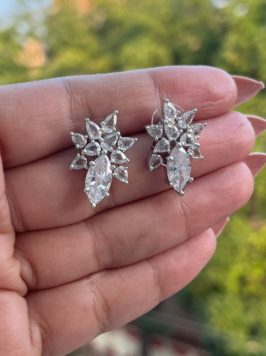 Shop Floral Studs Earrings In CZ Stones Rhodium Polish online in India. Shop from an exclusive range of zircon jewellery, Indian wedding jewelry, gold plated earrings, rhodium plated jewellery, AD earrings, AD necklace sets for weddings, engagements and parties. -front