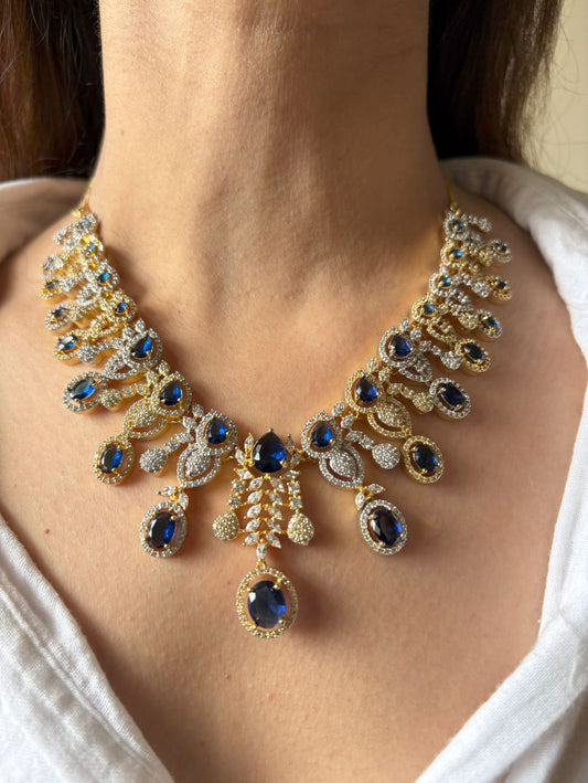 Shop Royal Sapphire Stone Heavy Necklace In AD With Gold & Rhodium Plating online in India. Explore elegant bridal AD jewellery online. Shop premium bridal jewellery sets in Zircon, AD, Kundan, Victorian Diamond. Collection best suited for Indian weddings, parties and special occasions. Choose AD Necklace in blue stone for sarees, lehengas and gowns. -front