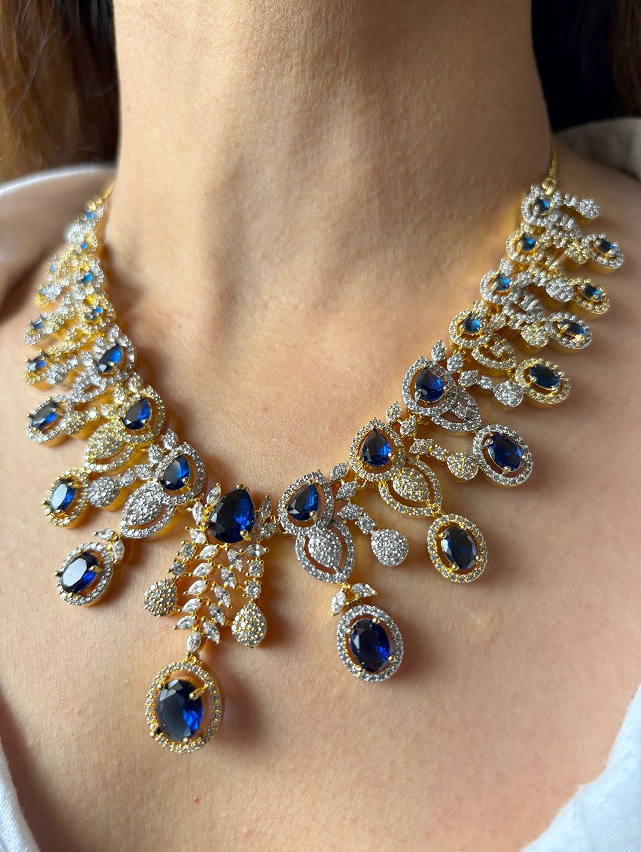 Shop Royal Sapphire Stone Heavy Necklace In AD With Gold & Rhodium Plating online in India. Explore elegant bridal AD jewellery online. Shop premium bridal jewellery sets in Zircon, AD, Kundan, Victorian Diamond. Collection best suited for Indian weddings, parties and special occasions. Choose AD Necklace in blue stone for sarees, lehengas and gowns. -full