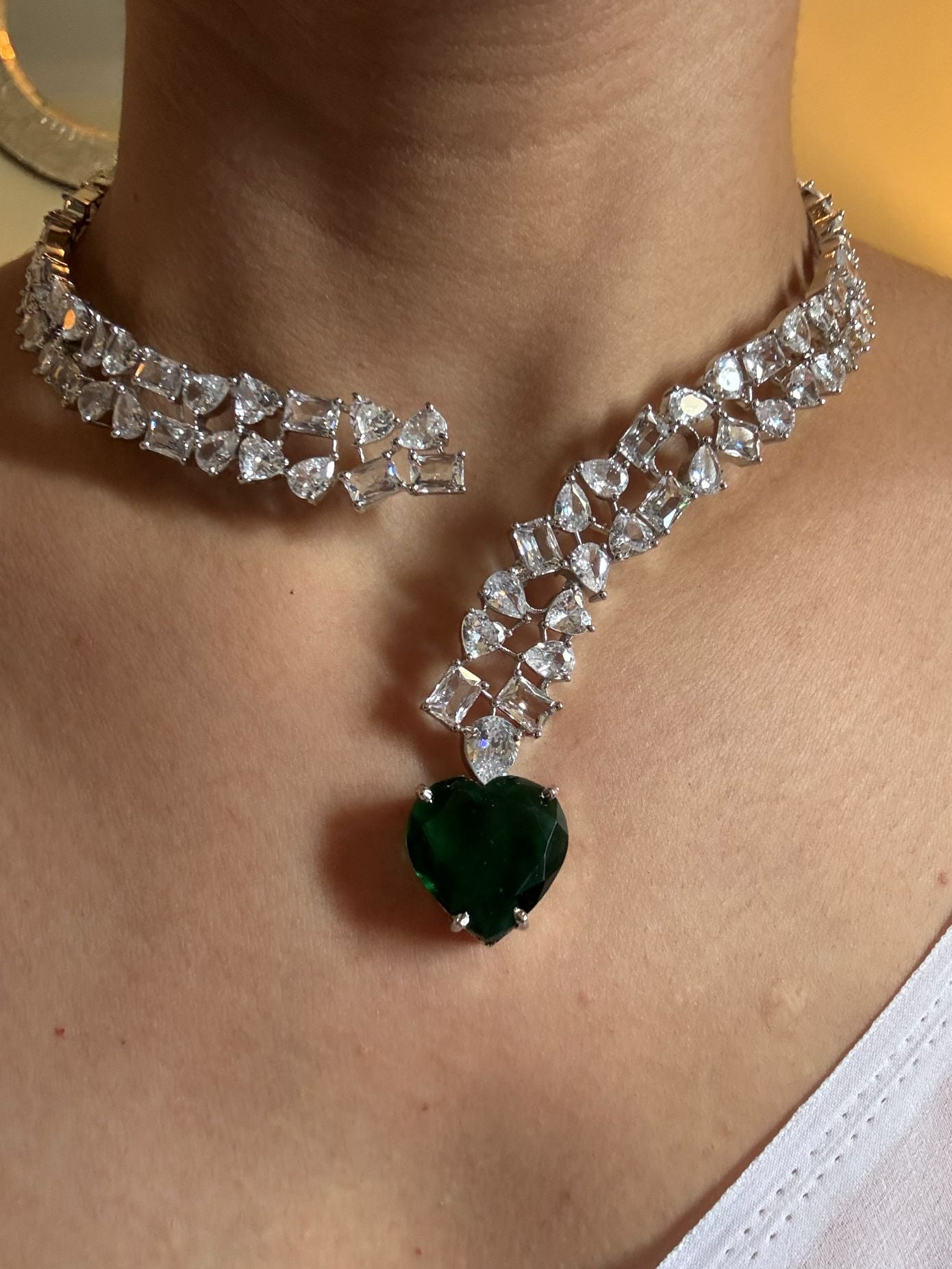 Shop Premium Hasli With Green Heart Pendant In CZ Stones online in India. Explore premium bridal jewellery online in AD. Shop AD jewellery in green stone online. -first