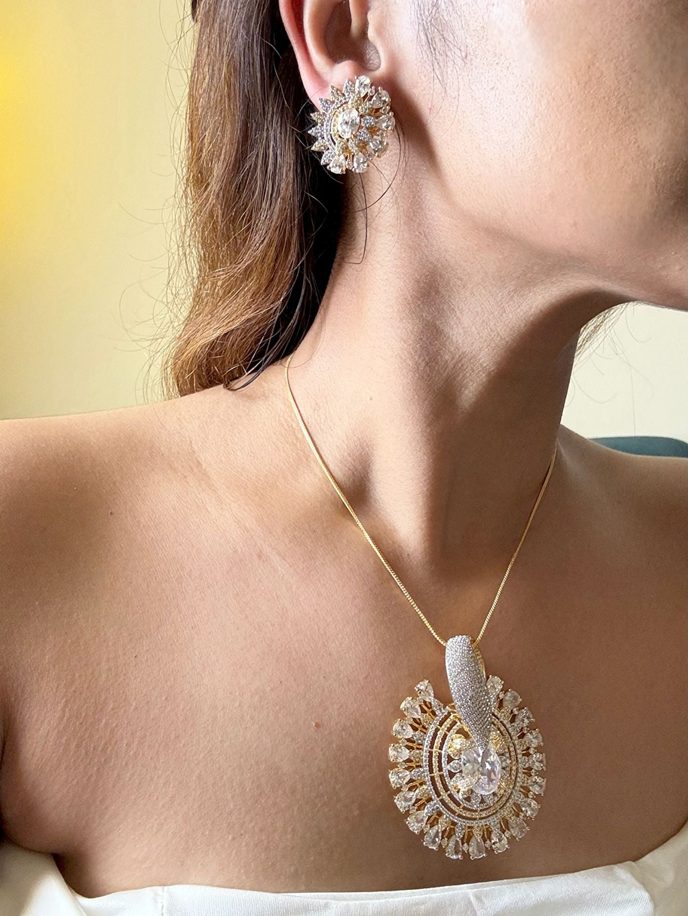 Shop Gorgeous Big Round Pendant Set In Gold & AD Stones Online in India. Pendant sets in different stones like Kundan, Moissanite, CZ stones and AD stones in all kinds quality are available online for purchase on website. Explore pendant sets for festive occasions perfect mothers and elderly ladies too. Pendant sets in green, blue, pink, red and white stones are available for wearing with sarees, lehengas, suits and Indo-westerns. -side