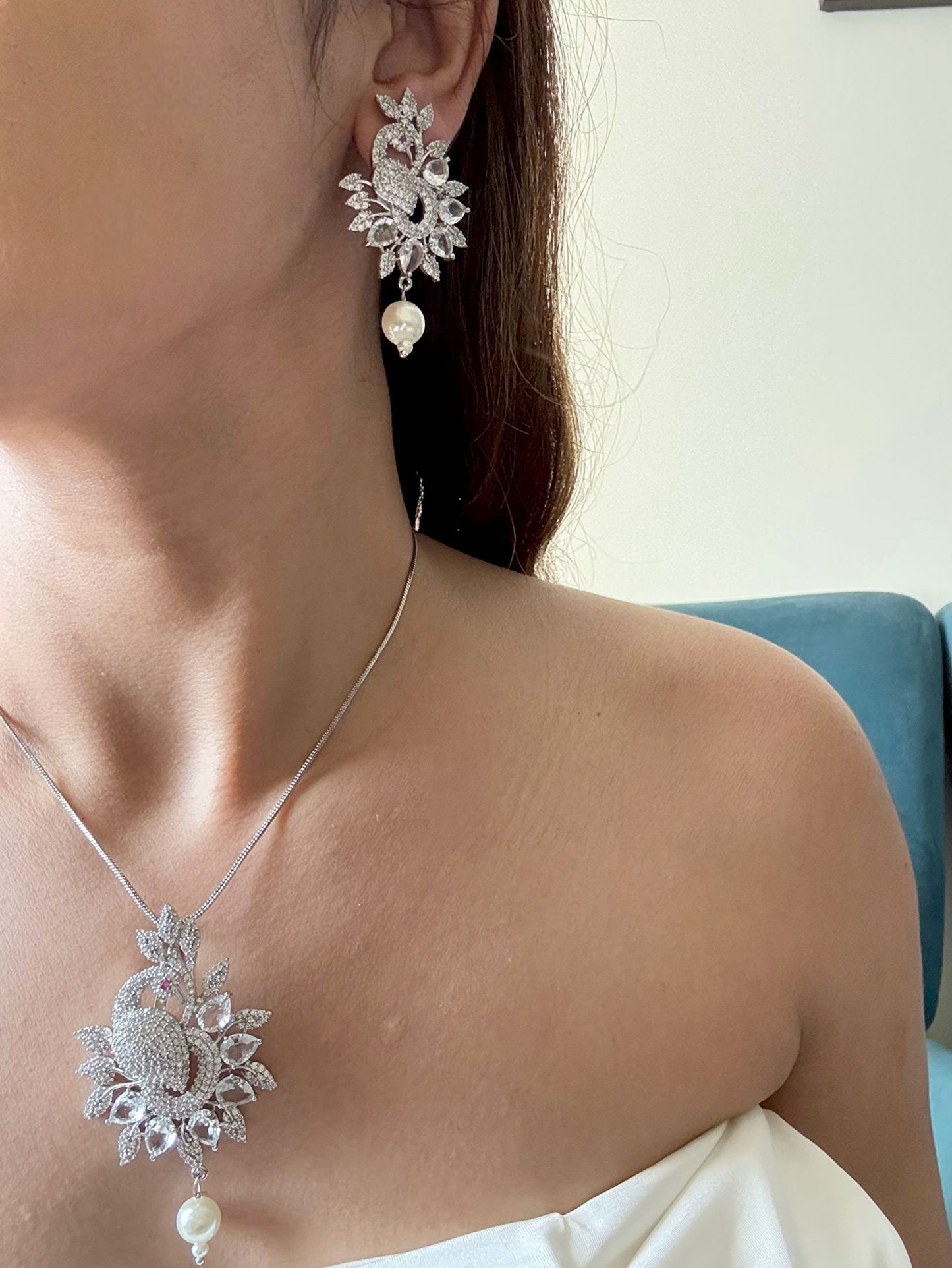 Shop Peacock Shaped Diamond Look Pendant Set In AD Online in India. Pendant sets in different stones like Kundan, Moissanite, CZ stones and AD stones in all kinds quality are available online for purchase on website. Explore pendant sets for festive occasions perfect mothers and elderly ladies too. Pendant sets in green, blue, pink, red and white stones are available for wearing with sarees, lehengas, suits and Indo-westerns. -FIRST