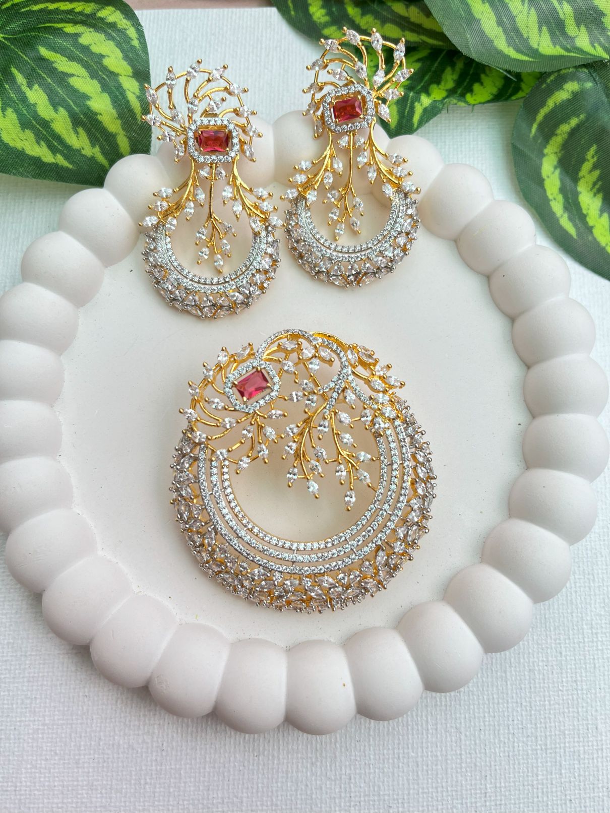 Shop Elegant Gold & Diamond Look Pendant Set in AD & Red Stone Online in India. Pendant sets in different stones like Kundan, Moissanite, CZ stones and AD stones in all kinds quality are available online for purchase on website. Explore pendant sets for festive occasions perfect mothers and elderly ladies too. Pendant sets in green, blue, pink, red and white stones are available for wearing with sarees, lehengas, suits and Indo-westerns. -withearrings