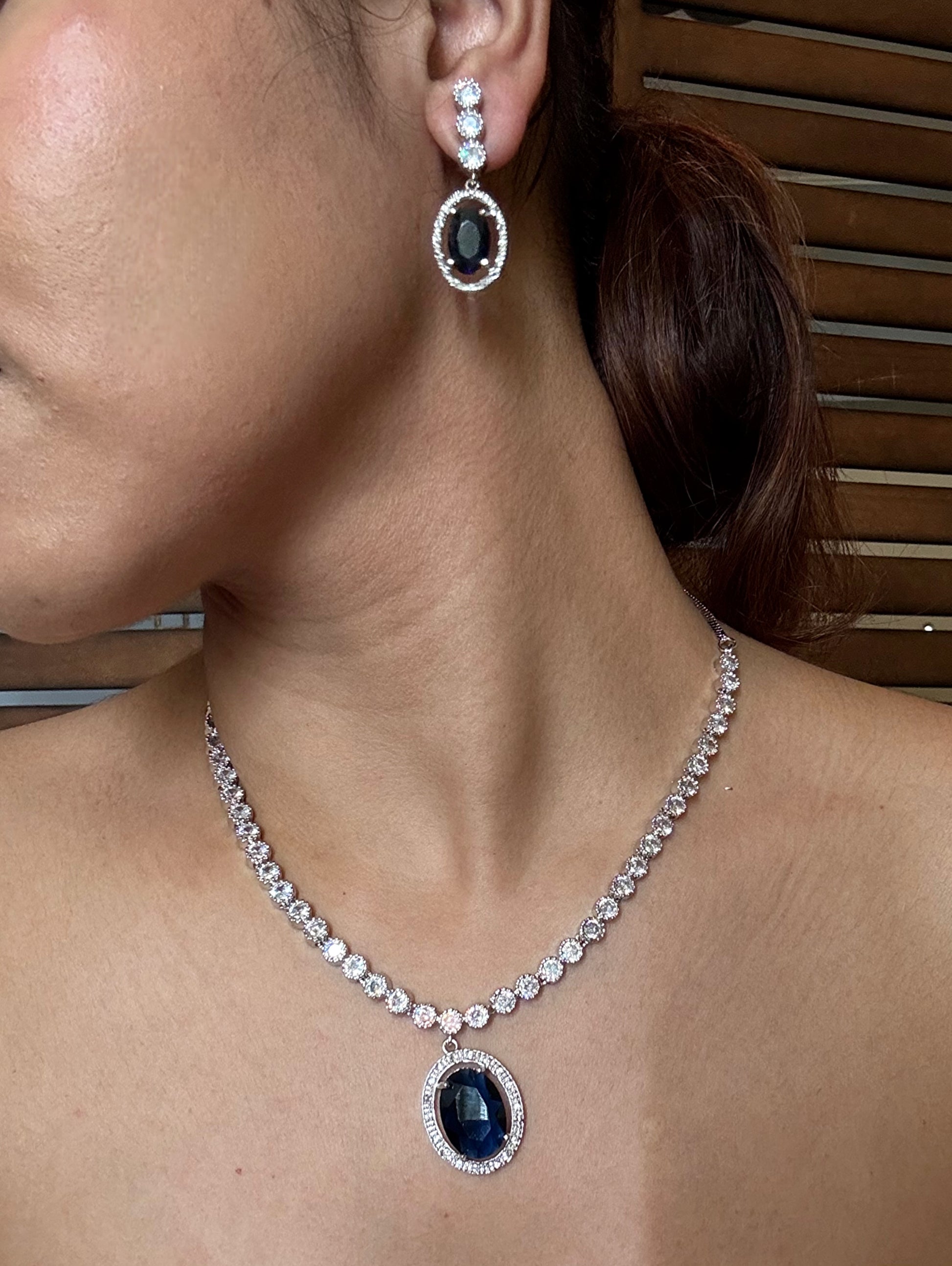 Shop blue pendant AD necklace online in India with earrings. Shop an exclusive range of zircon jewellery, Indian wedding jewelry, kundan jewellery, AD earrings, AD necklace.-side