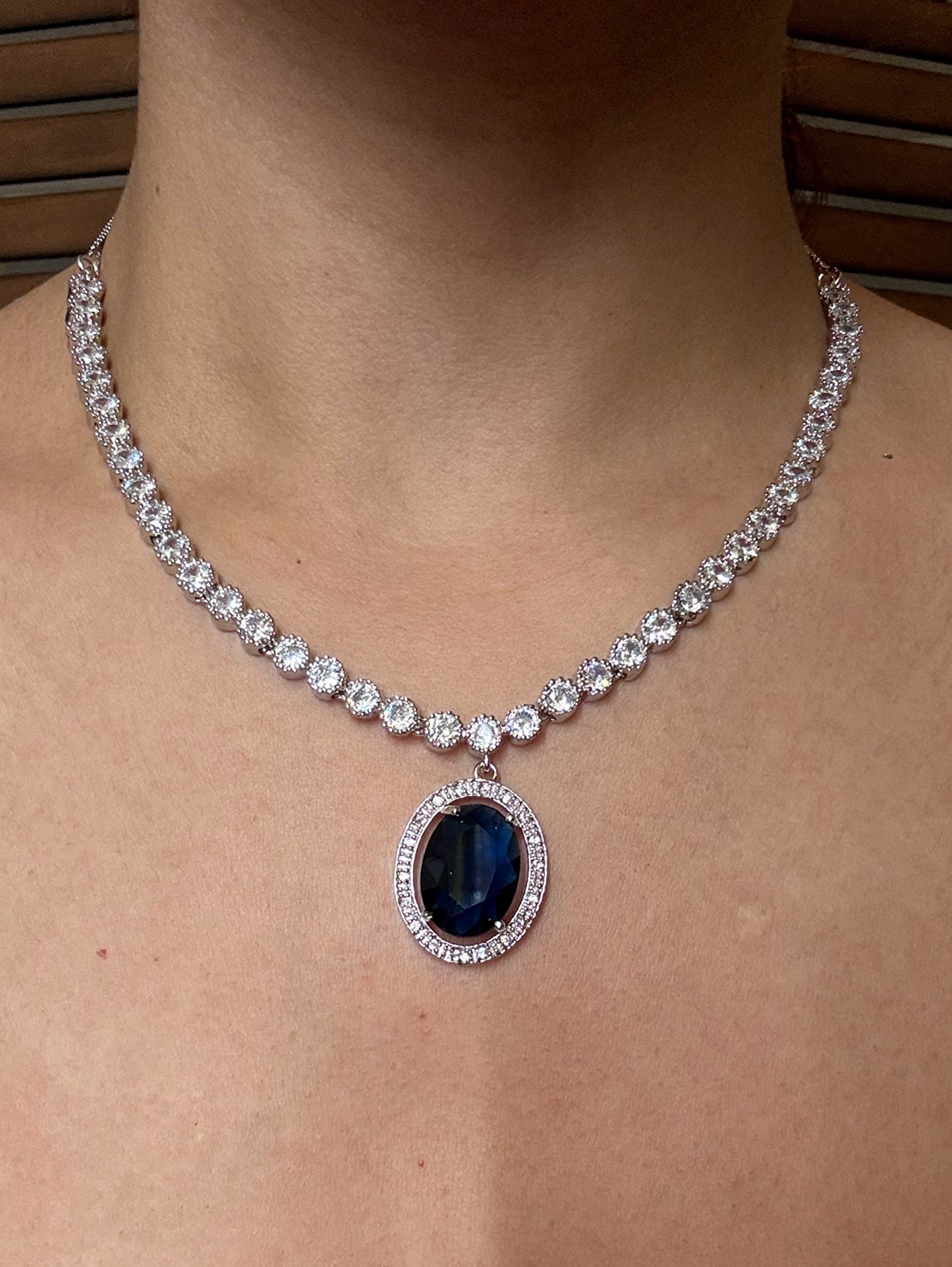 Shop blue pendant AD necklace online in India with earrings. Shop an exclusive range of zircon jewellery, Indian wedding jewelry, kundan jewellery, AD earrings, AD necklace.-front