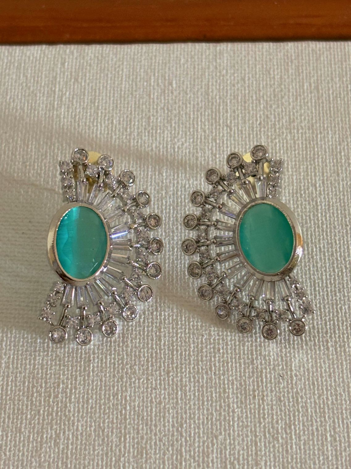 Shop women's luxury mint green stone AD ear cuffs online. Shop from an exclusive range of zircon earrings, bridal AD jewelry, silver plated earrings, rhodium plated jewellery, AD earrings, AD necklace sets for weddings, engagements and parties.  -front