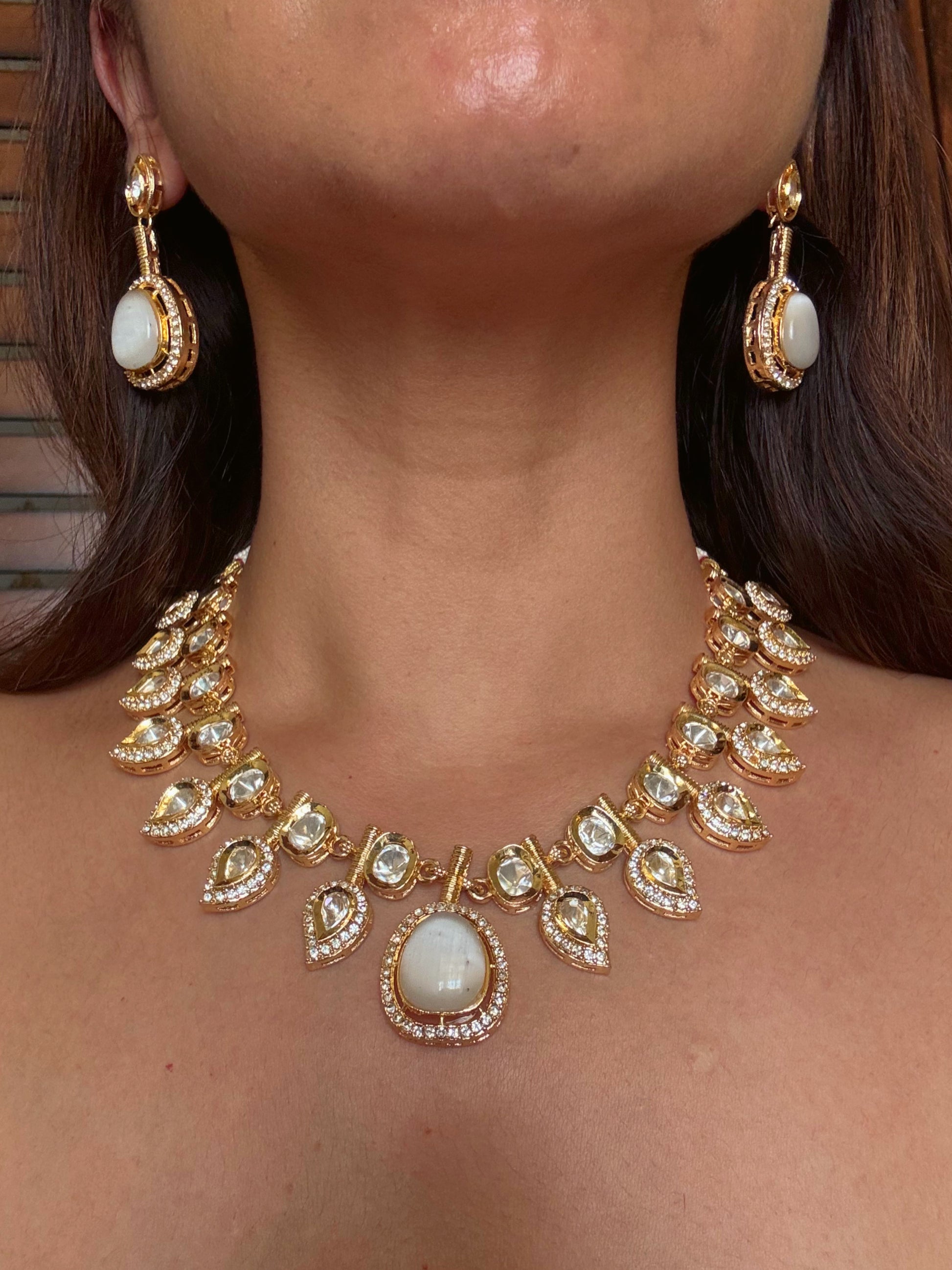 Buy white double and kundan gold plated necklace set online in India. Shop from an exclusive range of CZ jewellery, gold plated, silver plated jewellery, gold polish earrings. front
