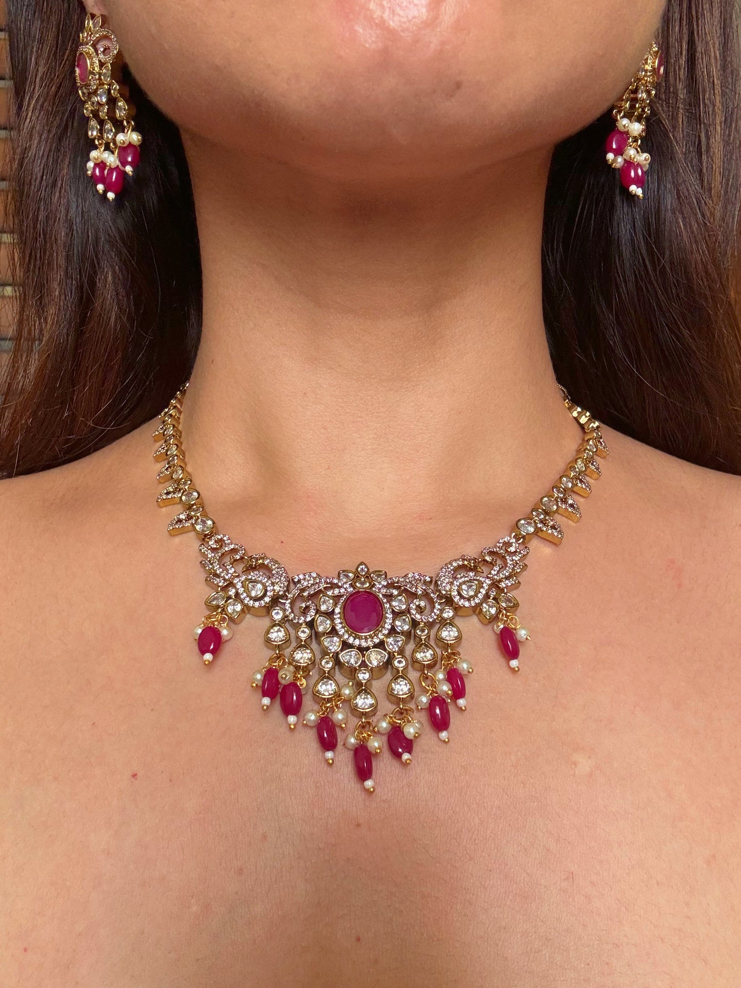Shop kundan and ruby gold plated necklace set online in India. Shop from an exclusive range of CZ jewellery, gold plated, silver plated jewellery, gold polish earrings. -front