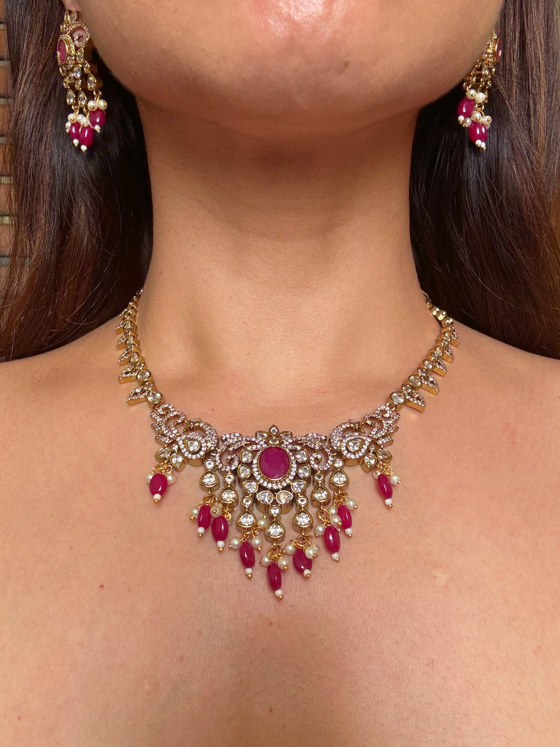 Shop kundan and ruby gold plated necklace set online in India. Shop from an exclusive range of CZ jewellery, gold plated, silver plated jewellery, gold polish earrings. -front
