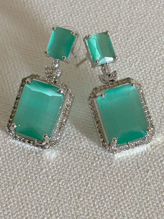 Shop women's luxury white doublet stone AD earrings online in India. Shop from an exclusive range of zircon jewellery, Indian wedding jewelry, AD earrings with saree, rhodium plated jewellery, AD necklace sets for weddings and engagement. AD jewellery in mint green stone. -front