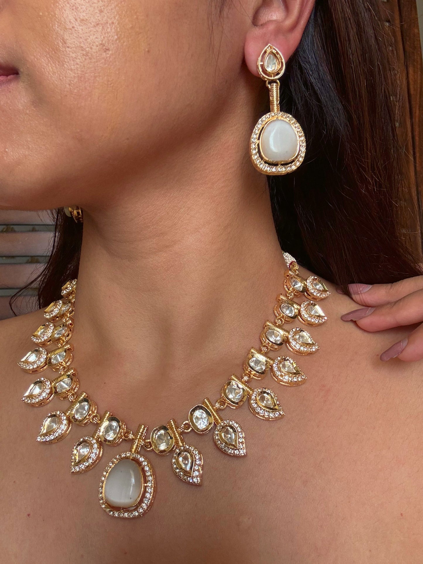 Buy white double and kundan gold plated necklace set online in India. Shop from an exclusive range of CZ jewellery, gold plated, silver plated jewellery, gold polish earrings. -full view