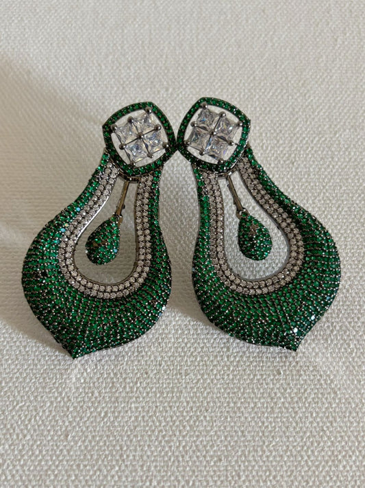 Shop celebrity look long AD Earrings online in green stones. Shop from an exclusive range of zircon earrings, bridal AD jewelry, silver plated earrings, rhodium plated jewellery, AD earrings, AD earrings sets for coats, gowns and lehengas.  -front
