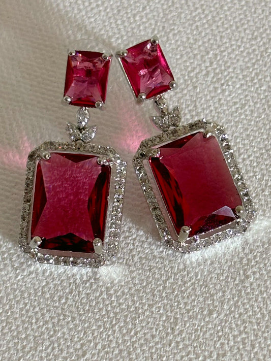 Shop women's luxury white doublet stone AD earrings online in India. Shop from an exclusive range of zircon jewellery, Indian wedding jewelry, AD earrings with saree, rhodium plated jewellery, AD necklace sets for weddings and engagement. AD jewellery in red stone. -front
