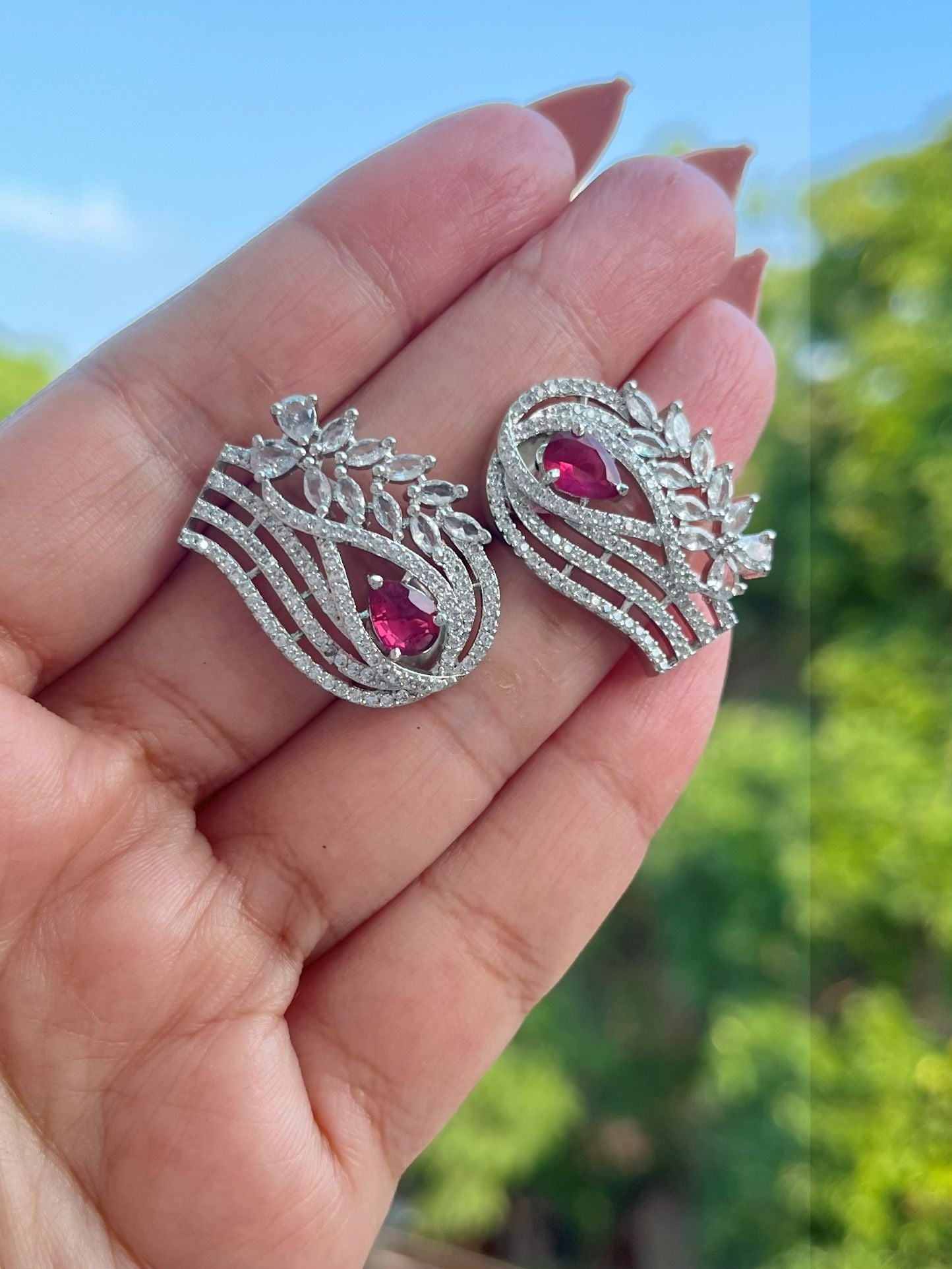 Shop Zuri Premium CZ Stones Stud Earrings In Red online in India. Shop AD earrings, bridal AD jewelry, AD necklace sets for weddings, engagements and parties.  