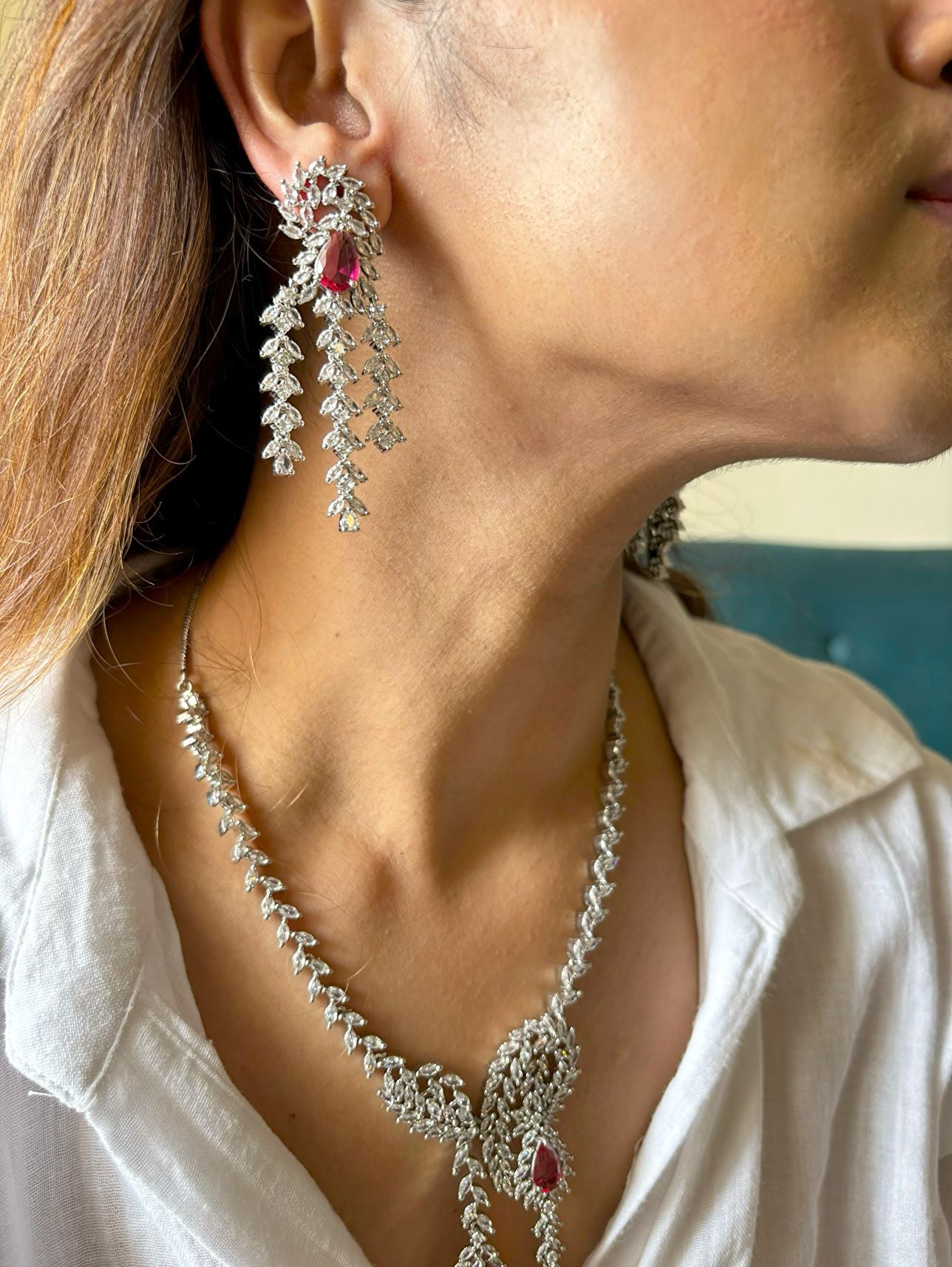Shop Heavy Long AD Necklace With Earrings In Red online in India. Explore elegant bridal AD jewellery online. Shop premium bridal jewellery sets in Zircon, AD, Kundan, Victorian Diamond. Collection best suited for Indian weddings, parties and special occasions. Choose AD Necklace In red stone for sarees, lehengas and gowns. -left