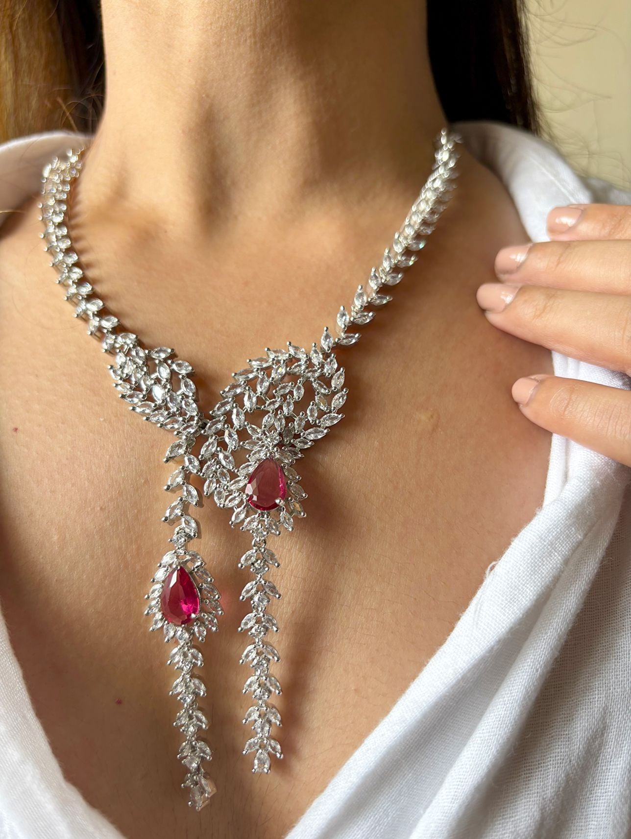 Shop Heavy Long AD Necklace With Earrings In Red online in India. Explore elegant bridal AD jewellery online. Shop premium bridal jewellery sets in Zircon, AD, Kundan, Victorian Diamond. Collection best suited for Indian weddings, parties and special occasions. Choose AD Necklace In red stone for sarees, lehengas and gowns. -front