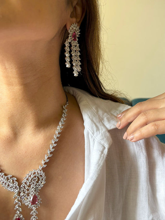 Shop Heavy Long AD Necklace With Earrings In Red online in India. Explore elegant bridal AD jewellery online. Shop premium bridal jewellery sets in Zircon, AD, Kundan, Victorian Diamond. Collection best suited for Indian weddings, parties and special occasions. Choose AD Necklace In red stone for sarees, lehengas and gowns. -side