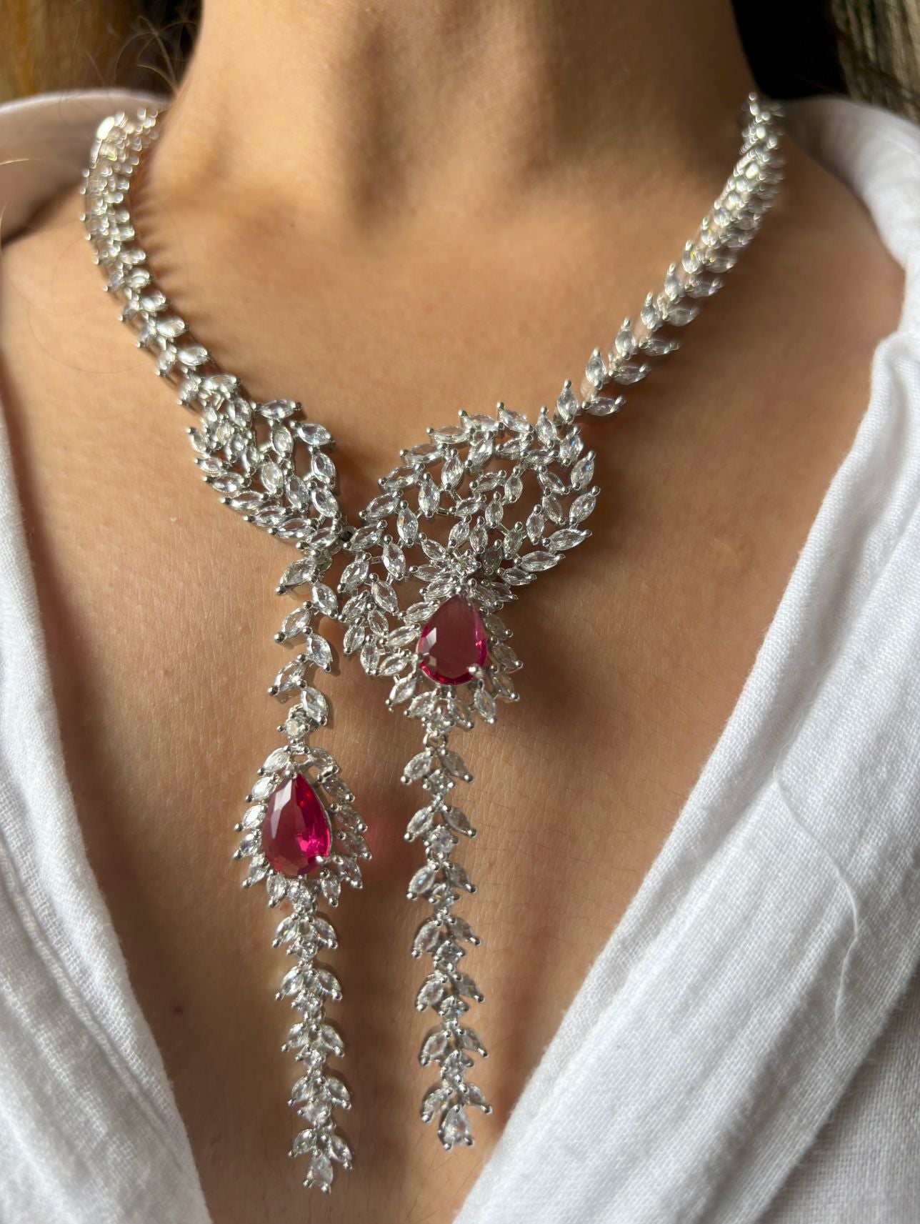 Shop Heavy Long AD Necklace With Earrings In Red online in India. Explore elegant bridal AD jewellery online. Shop premium bridal jewellery sets in Zircon, AD, Kundan, Victorian Diamond. Collection best suited for Indian weddings, parties and special occasions. Choose AD Necklace In red stone for sarees, lehengas and gowns. -back
