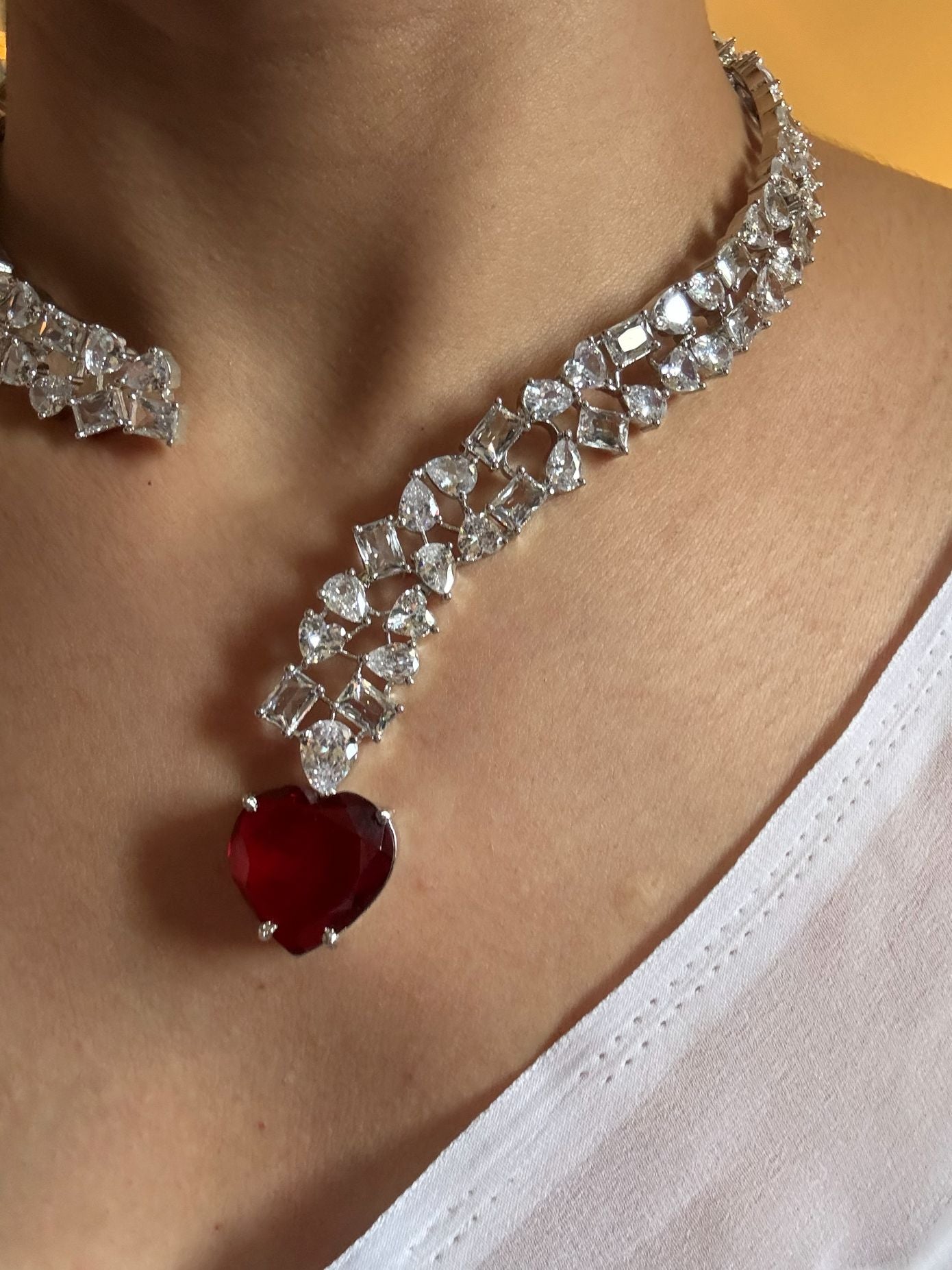 Shop Premium Hasli With Heart Pendant In CZ Stones online in India. Explore premium bridal jewellery online in AD. Shop AD jewellery in green stone online. -second