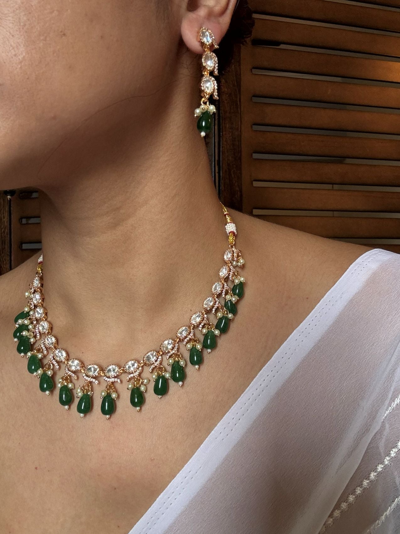 Buy Kundan Emerald Drops Necklace With Earrings online in India. Explore premium doublet stones jewellery online in AD. Shop AD jewellery in blue stone online. -side