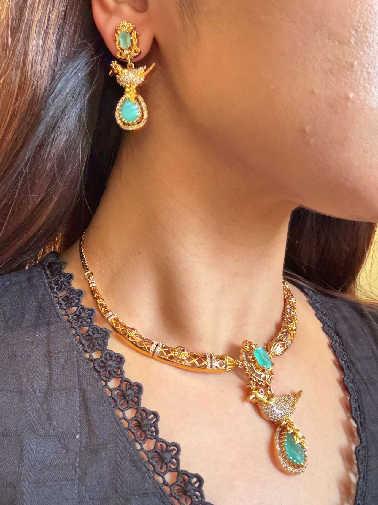 Buy Meghna Gold Plated Hasli Necklace In AD & Mint Green Stones online in India. Shop from an exclusive range of CZ jewellery, gold plated, silver plated jewellery. -side
