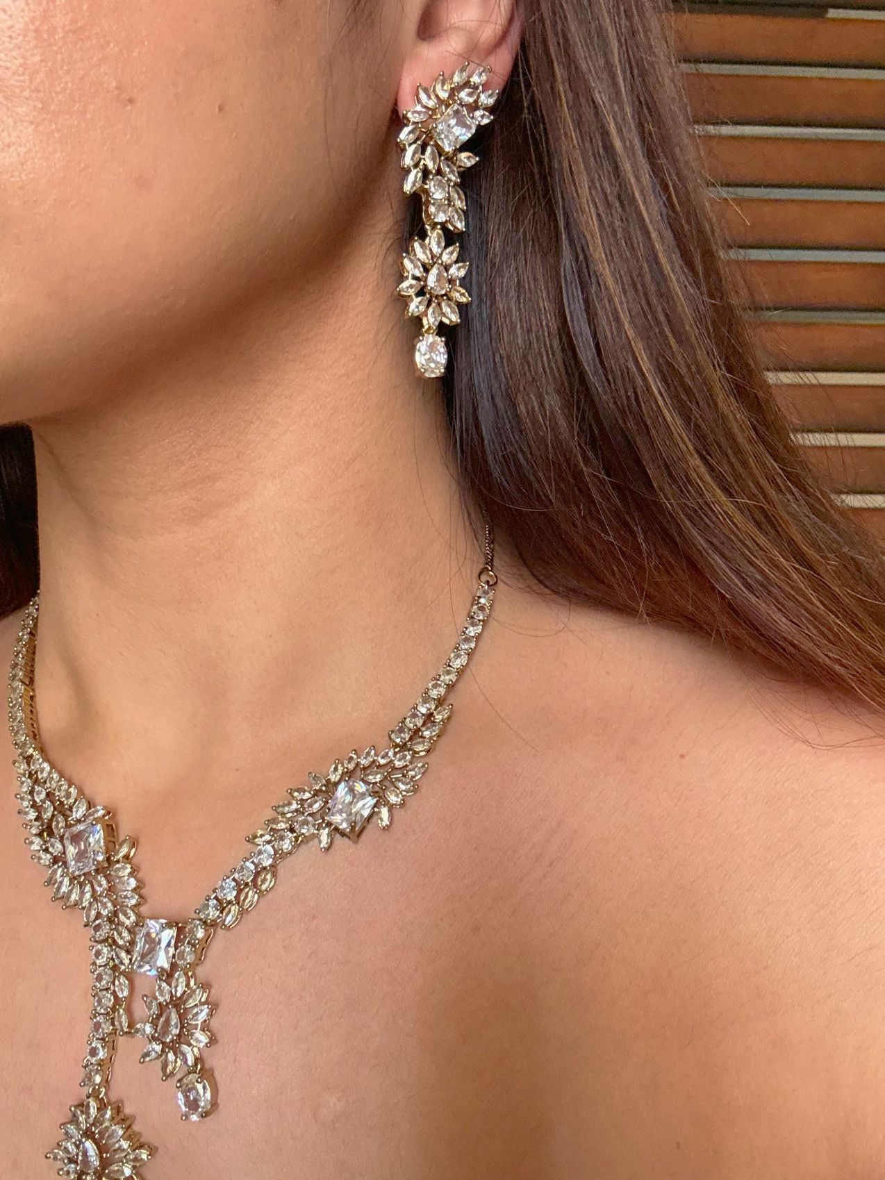 Buy Aarini White AD Heavy Necklace With Maang Tikka online in India. Shop from an exclusive range of CZ jewellery, gold plated, silver plated jewellery. -side