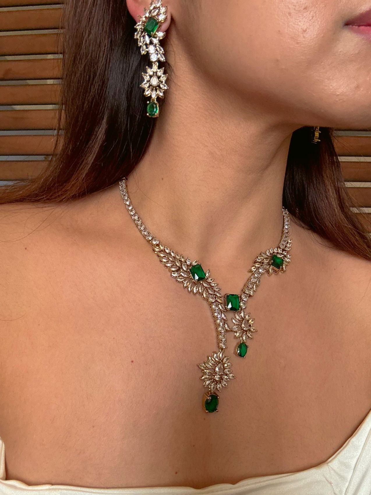 Buy Aarini Green AD Heavy Necklace With Maang Tikka online in India. Shop from an exclusive range of CZ jewellery, gold plated, silver plated jewellery. -side