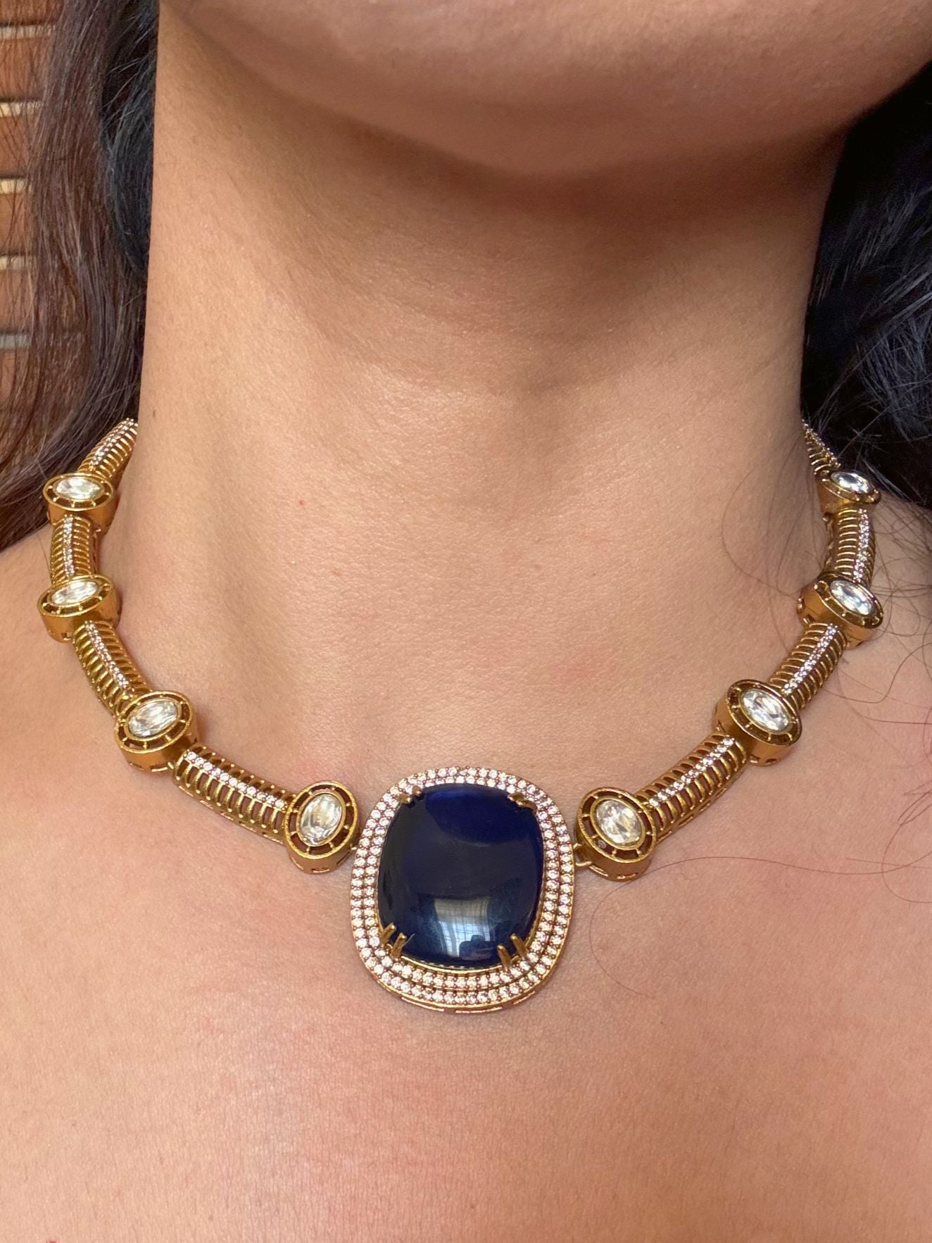 Buy Dharini Gold Polish Hasli Necklace In Navy Blue With Studs online in India. Shop from an exclusive range of moissanite jewellery, AD necklace, Kundan necklace for weddings. -front
