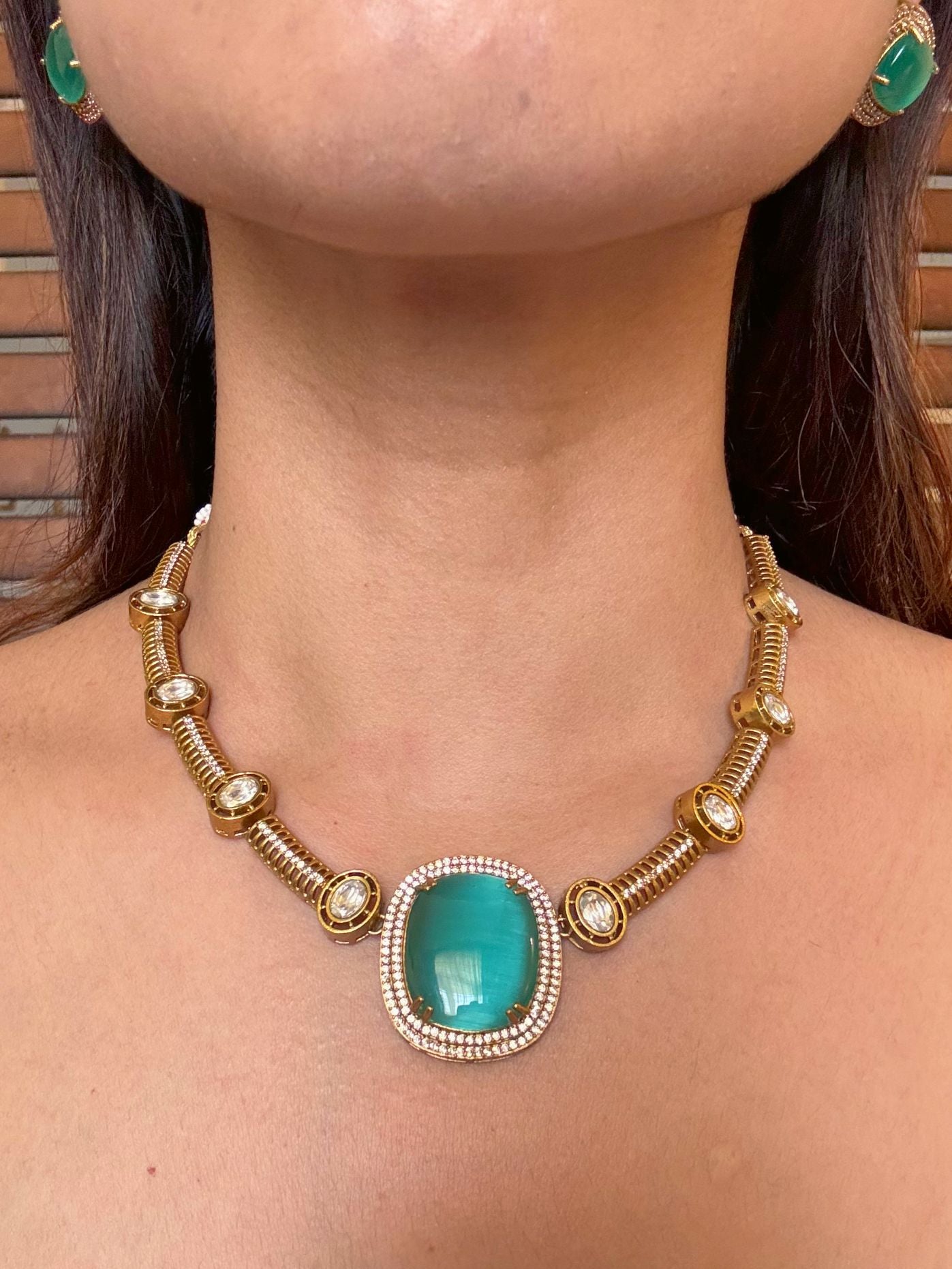 Buy Dharini Gold Polish Hasli Necklace In Mint Green With Studs online in India. Shop from an exclusive range of moissanite jewellery, AD necklace, Kundan necklace for weddings. -front