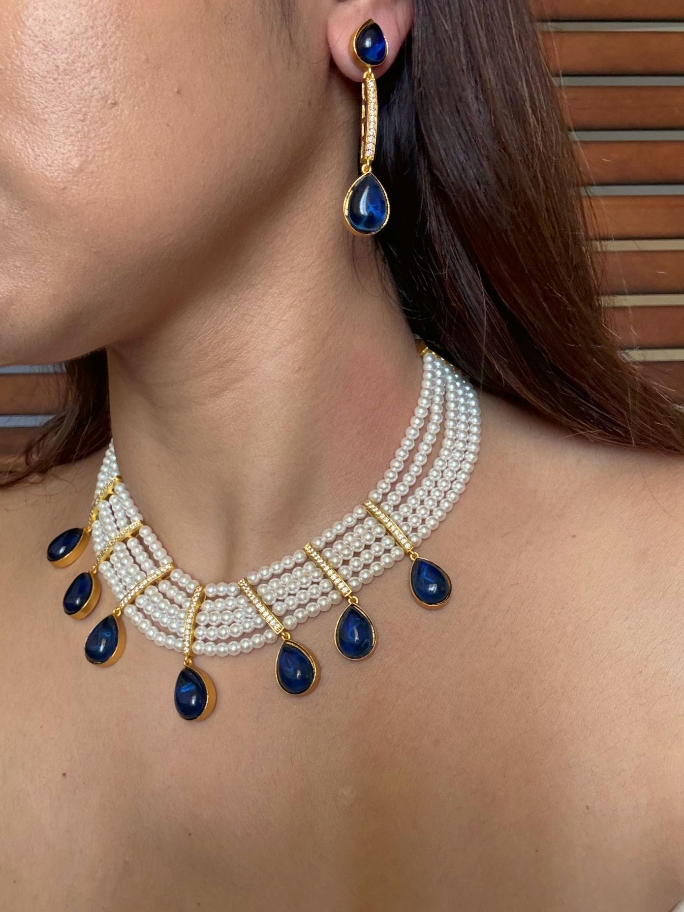 Buy Priyaanka Pearl Necklace With Blue Stone Drops online in India. Shop from an exclusive range of CZ jewellery, moissanite jewellery, AD necklace, Kundan necklace for weddings. -side