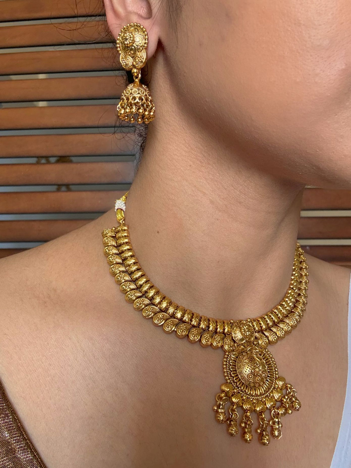 Buy Jeevika Antique Gold Brass Wedding Necklace online in India. Shop from an exclusive range of jewellery, gold imitation necklace, brass necklace for weddings. -side