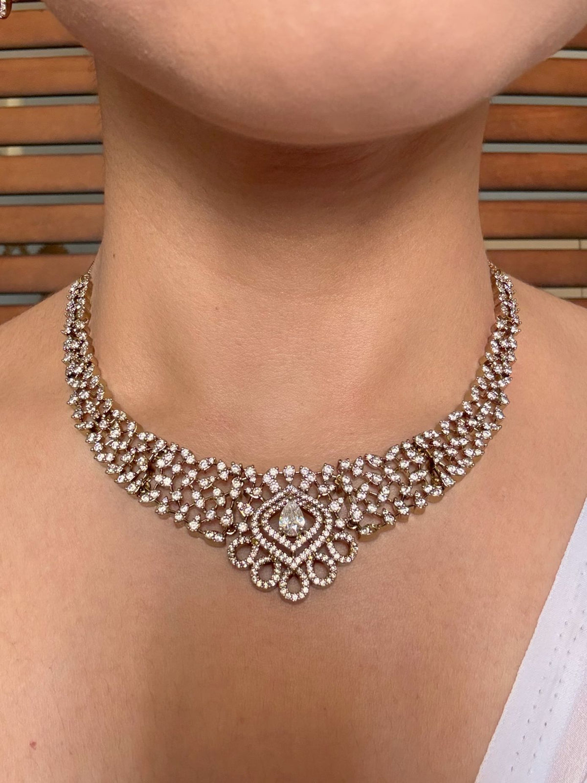Shop Suganda Elegant AD Necklace In White With Earrings online in India. Shop from an exclusive range of jewellery, gold imitation necklace, brass necklace for weddings. -front