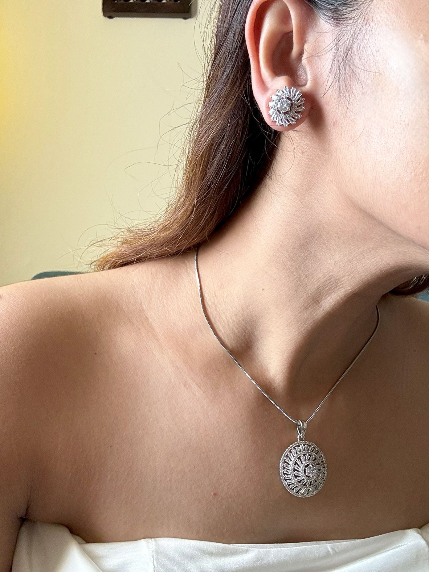 Shop Kiara Round Pendant Set With Studs In AD Online in India. Pendant sets in different stones like Kundan, Moissanite, CZ stones and AD stones in all kinds quality are available online for purchase on website. Explore pendant sets for festive occasions perfect mothers and elderly ladies too. Pendant sets in green, blue, pink, red and white stones are available for wearing with sarees, lehengas, suits and Indo-westerns. -withearrings