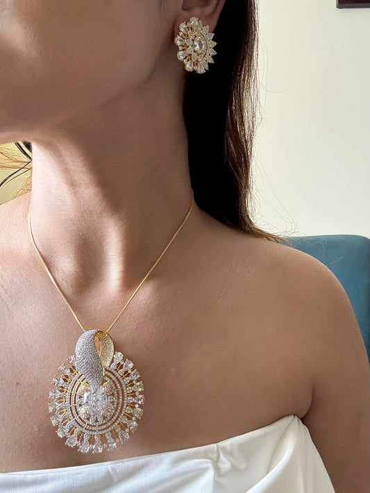 Shop Gorgeous Big Round Pendant Set In Gold & AD Stones Online in India. Pendant sets in different stones like Kundan, Moissanite, CZ stones and AD stones in all kinds quality are available online for purchase on website. Explore pendant sets for festive occasions perfect mothers and elderly ladies too. Pendant sets in green, blue, pink, red and white stones are available for wearing with sarees, lehengas, suits and Indo-westerns. -front