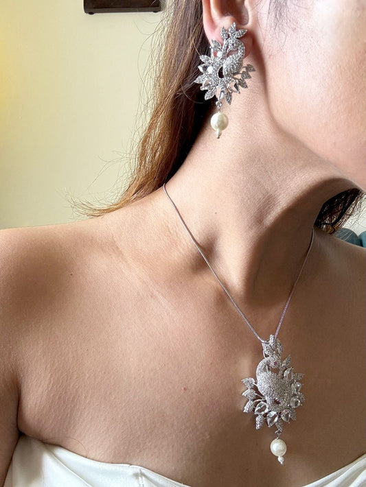 Shop Peacock Shaped Diamond Look Pendant Set In AD Online in India. Pendant sets in different stones like Kundan, Moissanite, CZ stones and AD stones in all kinds quality are available online for purchase on website. Explore pendant sets for festive occasions perfect mothers and elderly ladies too. Pendant sets in green, blue, pink, red and white stones are available for wearing with sarees, lehengas, suits and Indo-westerns. -Second