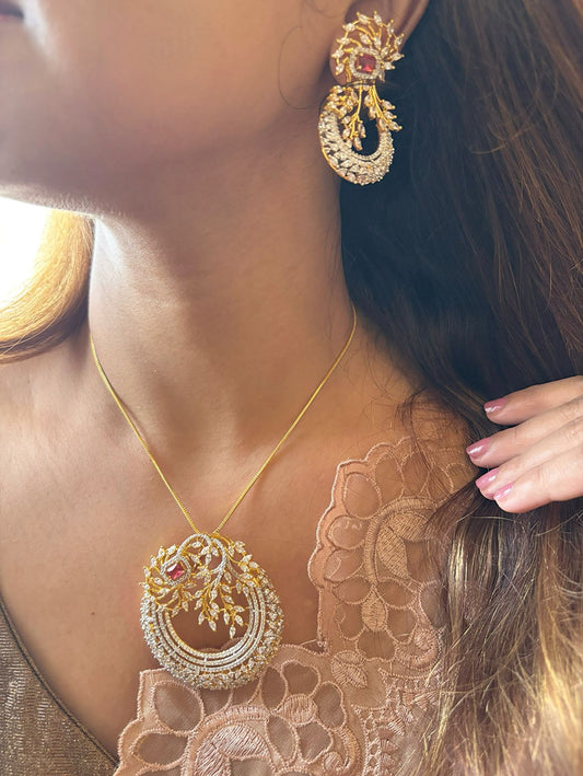 Shop Elegant Gold & Diamond Look Pendant Set in AD & Red Stone Online in India. Pendant sets in different stones like Kundan, Moissanite, CZ stones and AD stones in all kinds quality are available online for purchase on website. Explore pendant sets for festive occasions perfect mothers and elderly ladies too. Pendant sets in green, blue, pink, red and white stones are available for wearing with sarees, lehengas, suits and Indo-westerns. -first