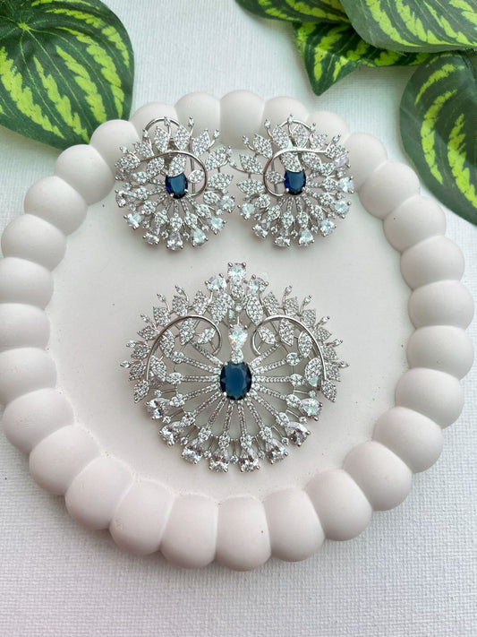 Shop Sapphire Love Floral Pendant Set In AD & Blue Stone Online in India. Pendant sets in different stones like Kundan, Moissanite, CZ stones and AD stones in all kinds quality are available online for purchase on website. Explore pendant sets for festive occasions perfect mothers and elderly ladies too. Pendant sets in green, blue, pink, red and white stones are available for wearing with sarees, lehengas, suits and Indo-westerns. -first