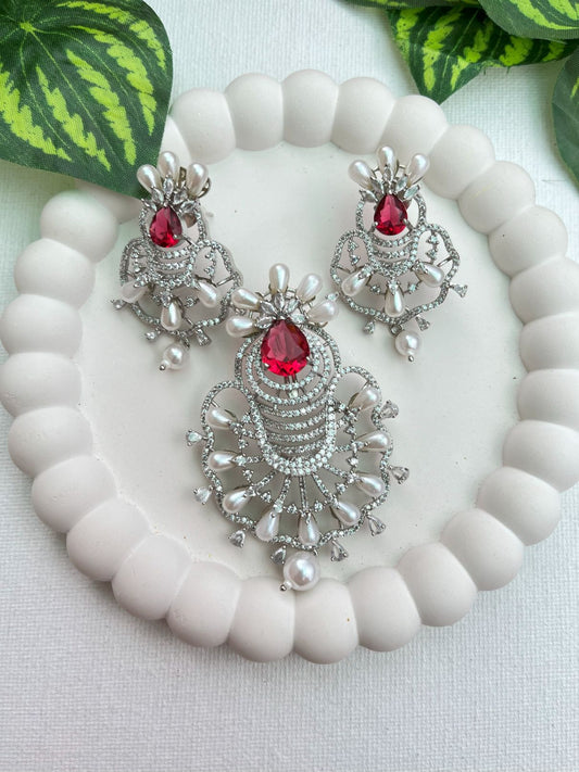 Shop Ruby Love Floral Pendant Set In AD & Pearls Online in India. Pendant sets in different stones like Kundan, Moissanite, CZ stones and AD stones in all kinds quality are available online for purchase on website. Explore pendant sets for festive occasions perfect mothers and elderly ladies too. Pendant sets in green, blue, pink, red and white stones are available for wearing with sarees, lehengas, suits and Indo-westerns. -front